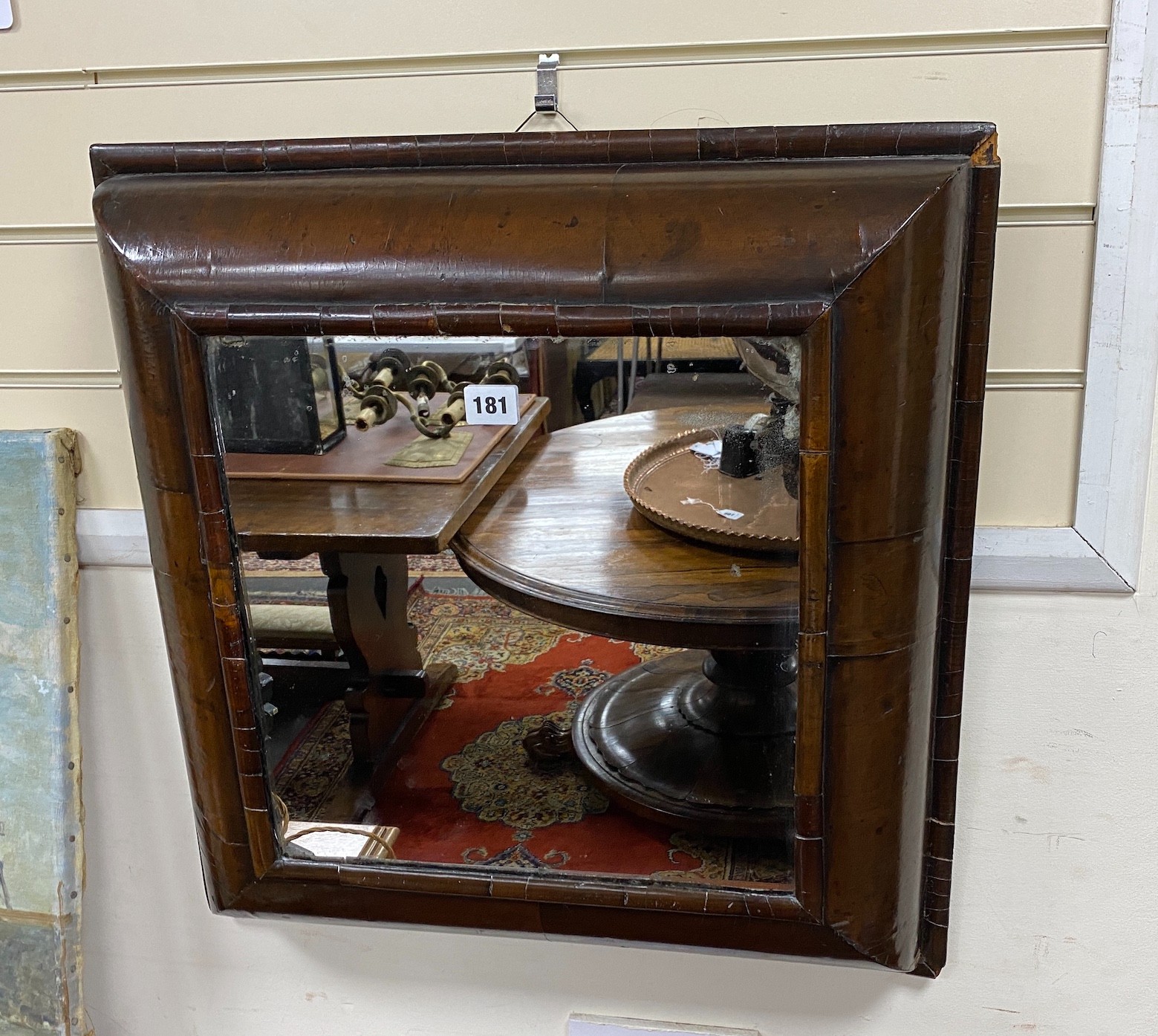 A William and Mary walnut veneered cushion framed wall mirror, width 56cm, height 57cm